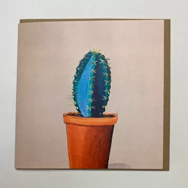 a single cactus in a pot on a cream background